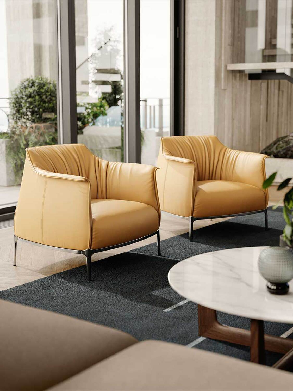 A pair of tan Archibald lounge chairs by Poltrona Frau in a contemporary interior