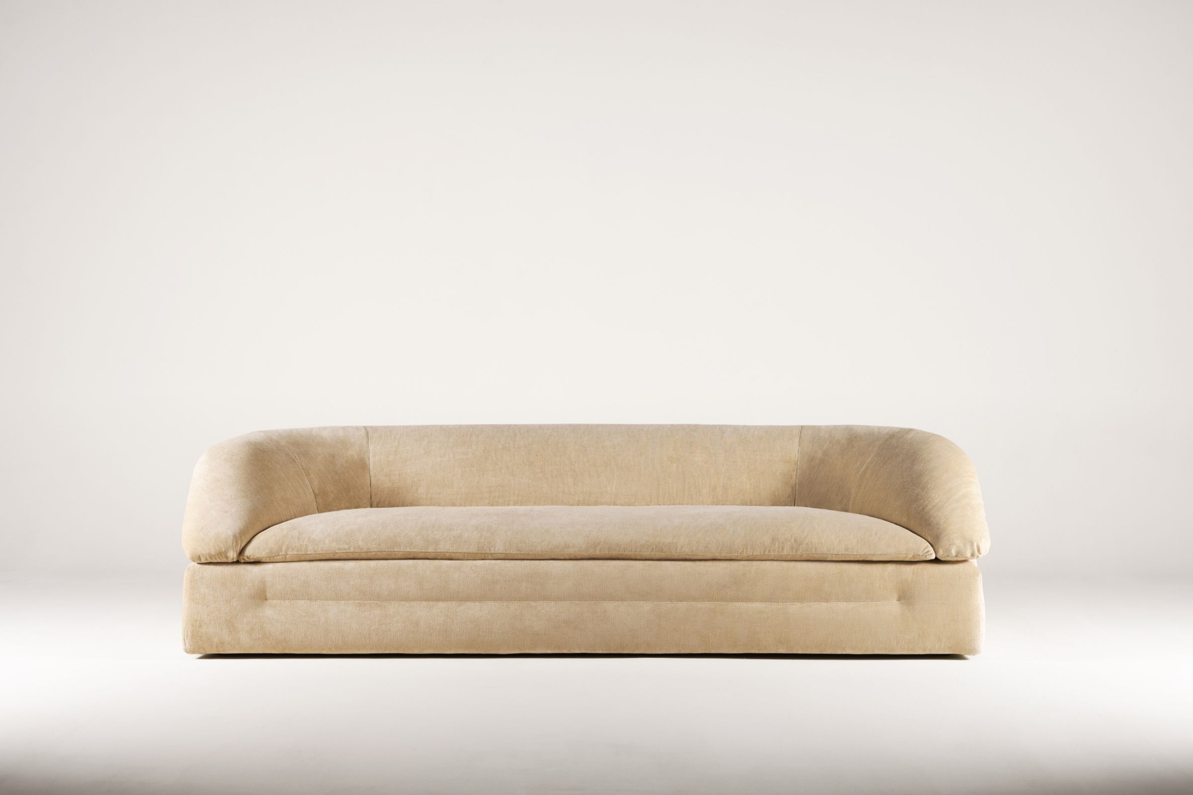 Butter sofa by Faye Toogood for Tacchini against a warm neutral backdrop