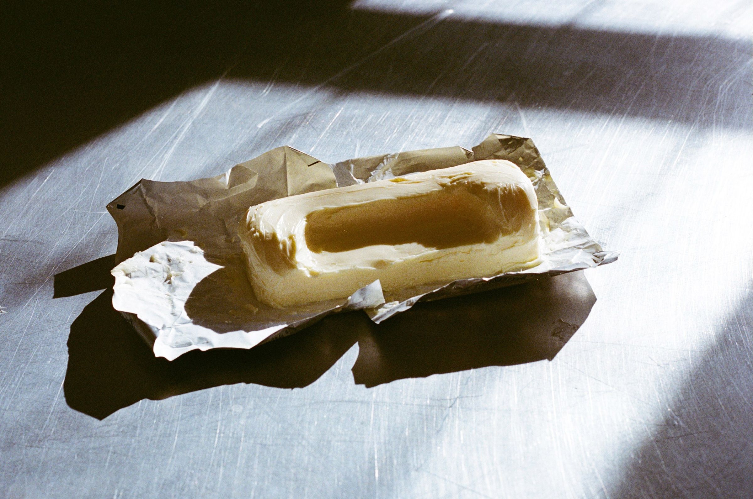 A sculpted stick of butter used as a form study for the Butter sofa