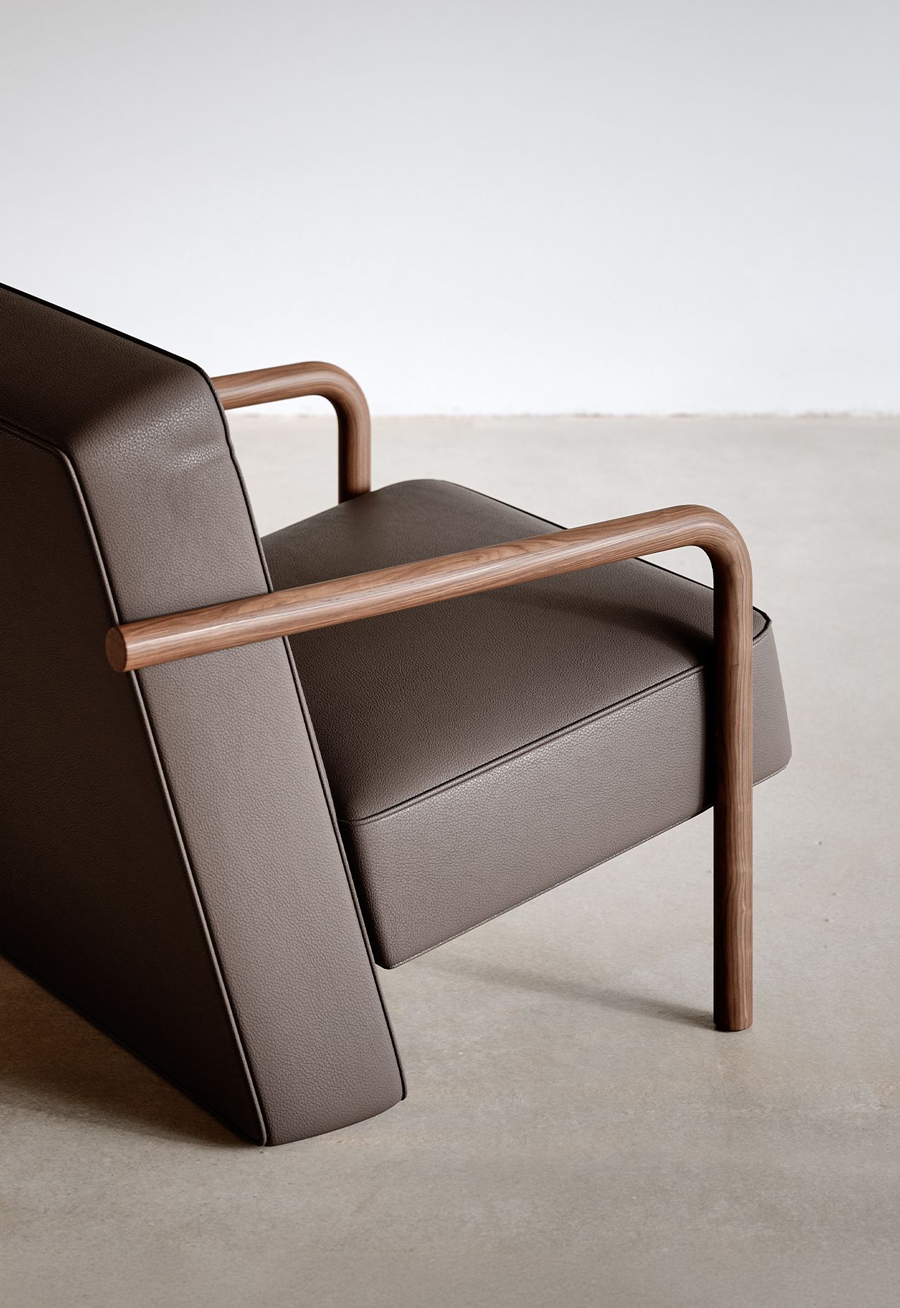 Close view of Parker's curved solid wood arm and upholstered seat