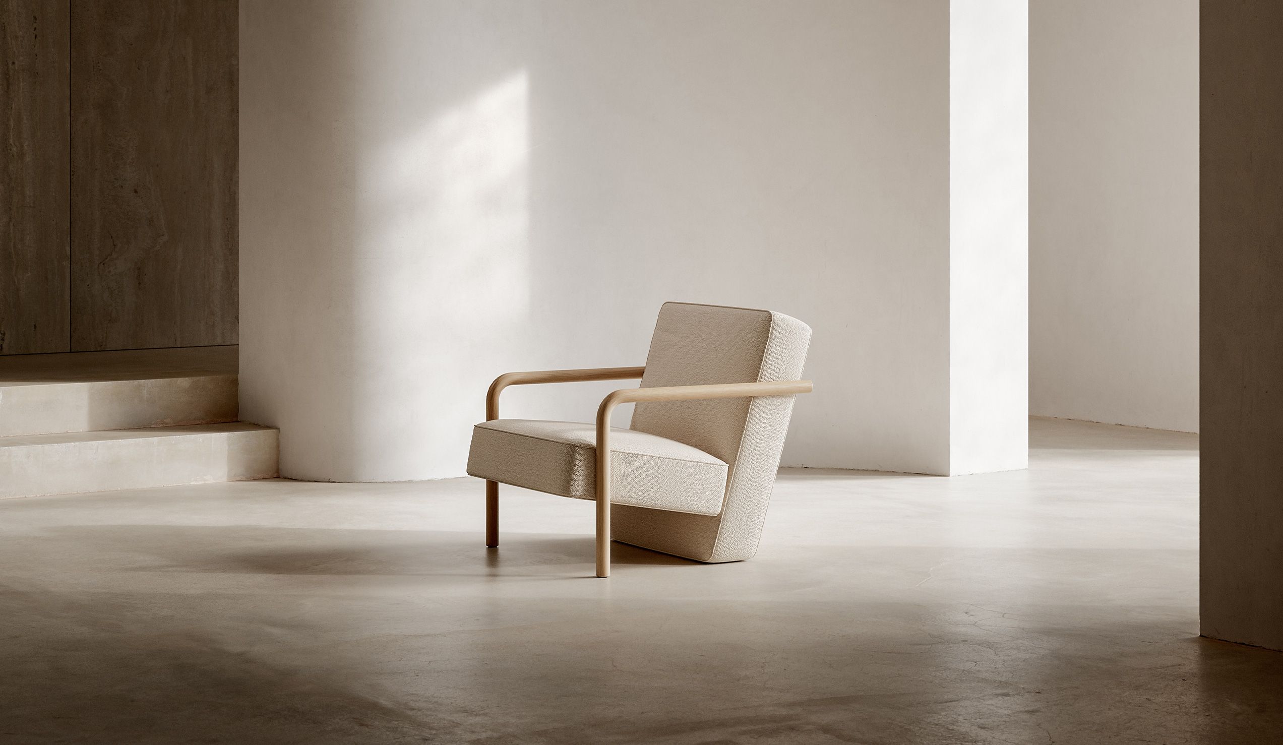 Single light upholstered Parker chair by Bensen in a sunlit architectural room